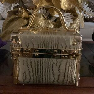 A gold lock box purse